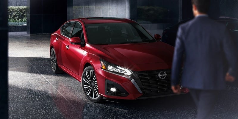 A driver walking up to their parked 2024 Nissan Altima in Mayfield Heights, OH