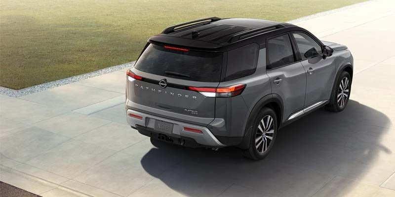 The rear of a 2024 Nissan Pathfinder driving by with powerful performance in Mayfield Heights, OH