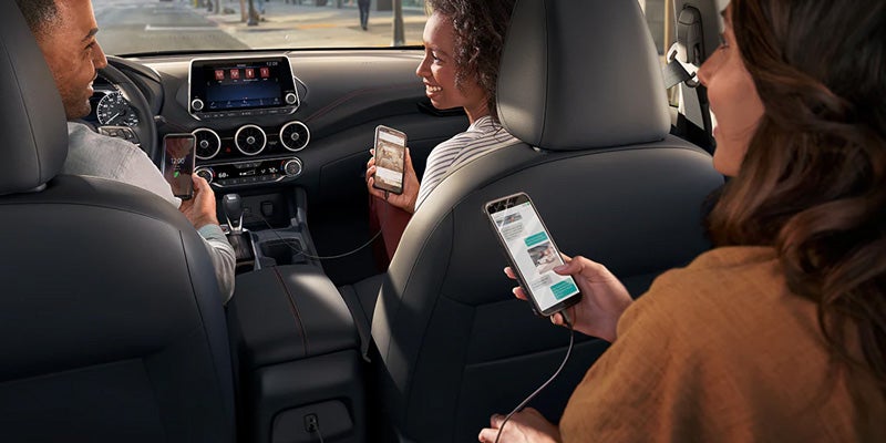 A backseat occupant is playing music in the 2024 Nissan Sentra in Mayfield Heights, OH