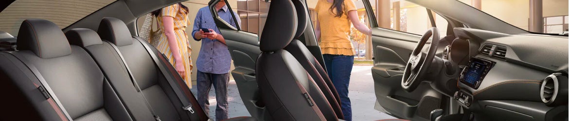 A family getting out of their 2025 Nissan Versa in Mayfield Heights, OH