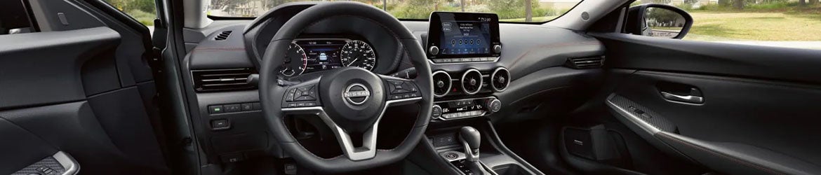 The steering wheel and center console of the 2025 Nissan Sentra in Mayfield Heights, OH